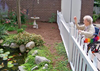 Linn Health Care Center - July/August 2012 - Feeding the Fish in Our Koi Pond