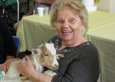 Emma Aglione holding a goat at the visiting petting zoo