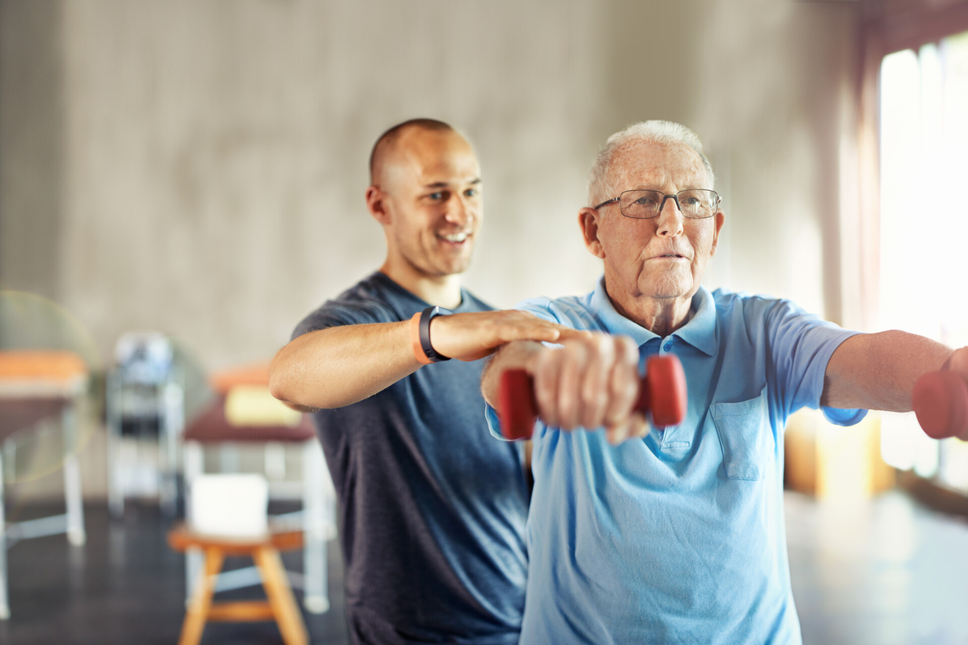 Forget About Age, Its Time To Engage. Shot Of A Senior Man Working Out With The Help Of A Trainer. Shot of a senior man working out with the help of a trainer
